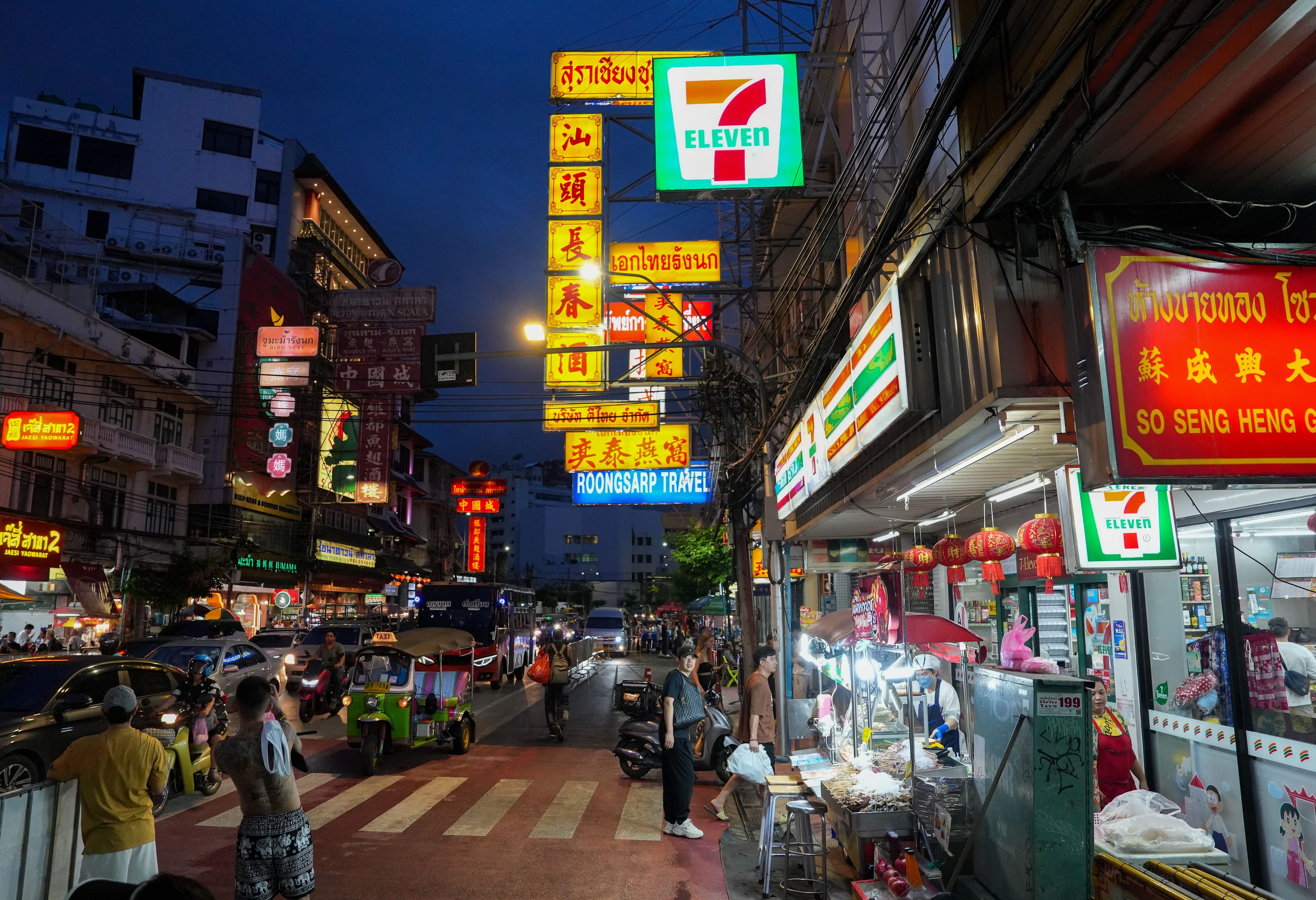 Yaowarat Road in Bangkok's Chinatown at night, under neon shop signs.